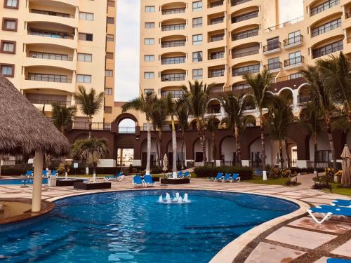 Bazén v ubytování Condominio de lujo a Pie de Playa nebo v jeho okolí