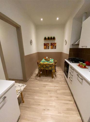 a kitchen with a table and a dining room at Alla Scalinata del Teatro Rossetti parcheggio in Trieste