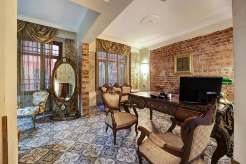 a living room with a desk and a brick wall at Hotel Fresia Istanbul in Istanbul