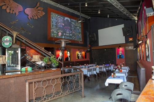 a restaurant with tables and chairs and a chalkboard at Planeta Macacos in Macacos