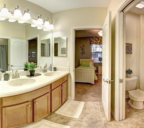 a bathroom with two sinks and a toilet at 2353VD - Providence A Gated Golf Community in Davenport