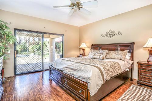 a bedroom with a bed and a ceiling fan at Alluring Palm Desert Retreat in Palm Desert