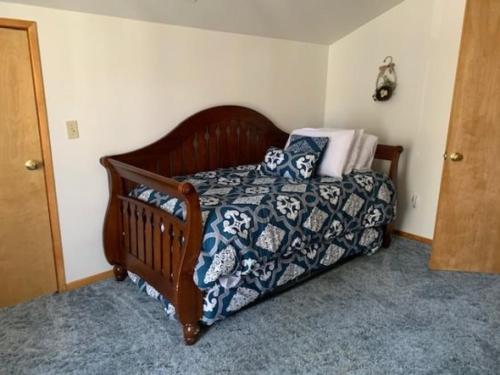 a bedroom with a wooden bed with pillows on it at Rr-june Lake Lodge in June Lake