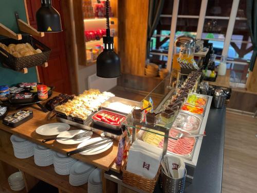 a buffet with food on a table in a kitchen at Penzion Zákoutí in Pec pod Sněžkou