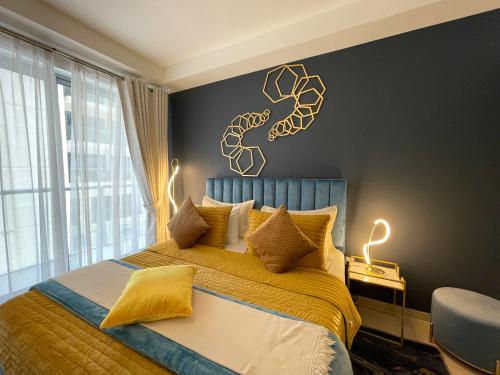 a bedroom with a bed with a fish on the wall at Fabulous 1 Bedroom Private Apartment - Waterfront Property in Ras al Khaimah