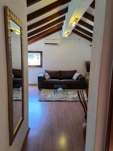 a living room with a couch and a mirror at Jees Exclusive Apartments Hvar in Stari Grad