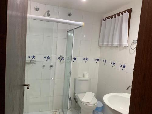 a bathroom with a toilet and a shower with blue stars on the wall at Pousada das Pedras Paraty -RJ in Paraty