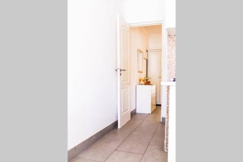 a hallway with white walls and a tile floor at Apartamento MareVerde Las Americas in Adeje