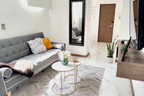a living room with a couch and a table at Orozco MaiaHome-POLANCO 1BR close to Antara in Mexico City