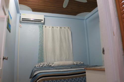 a small room with a window and a curtain at Ocean Views and Hospitable Hosts in Castries