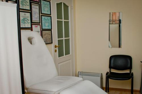 a room with a bed and a chair and a door at Vijuandra in Zarasai