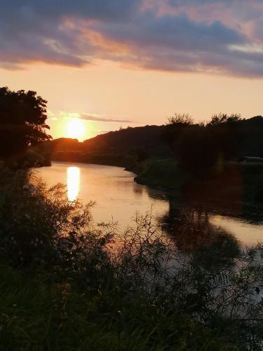 a sunset over a river with the sun setting at Cable Island Bed and Breakfast in Cork