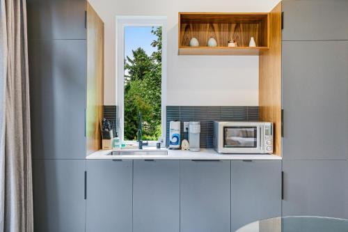 a kitchen with a microwave and a window at The Treehouse in Seattle