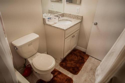 a bathroom with a white toilet and a sink at Spacious Home, Close to Attractions, Sleeps 4 in Orlando