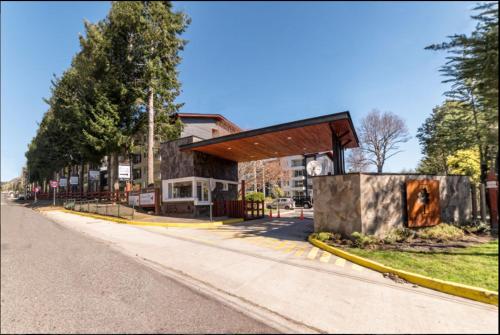 a bus stop on the side of a street at Exceptional Deluxe Apartment Pucon near Lake and Volcano in Pucón