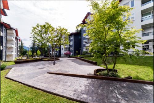 a park in a city with a tree and buildings at Exceptional Deluxe Apartment Pucon near Lake and Volcano in Pucón