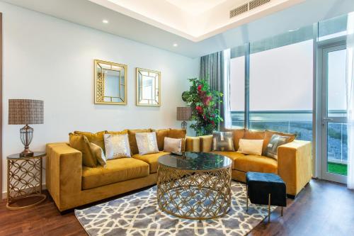 a living room with a couch and a table at Live feel and get lost in waters in Ras al Khaimah