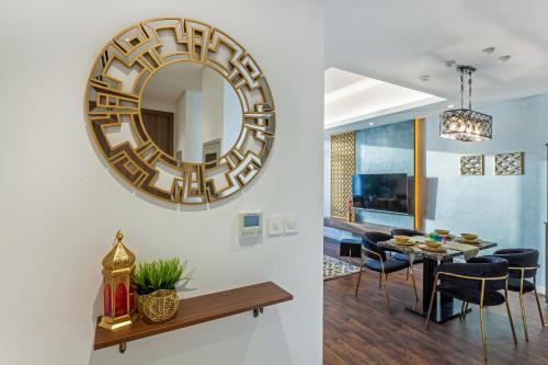 a dining room and living room with a mirror on the wall at Live feel and get lost in waters in Ras al Khaimah