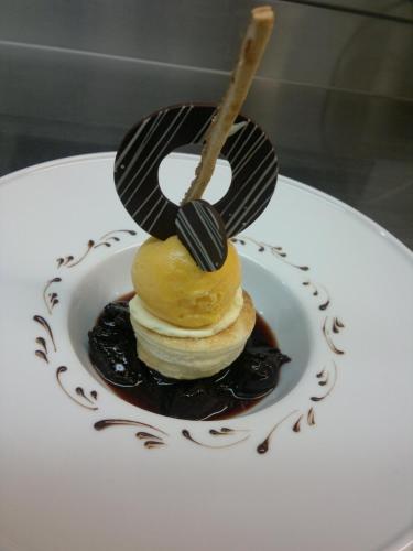 a dessert with a number on a plate with chocolate sauce at Rezas Restaurant Gästehaus in Oberbillig