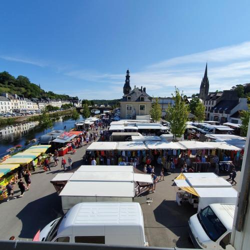 a group of stalls in a market next to a river at Chambres Dhôtes Numéro 1 in Châteaulin
