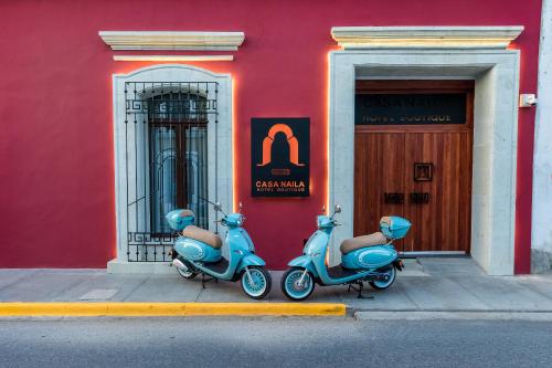 two scooters parked in front of a building at Casa Naila Hotel Boutique in Oaxaca City