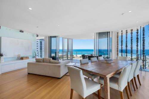 a dining room with a table and chairs and the ocean at Silver Sea on Sixth Resort in Maroochydore