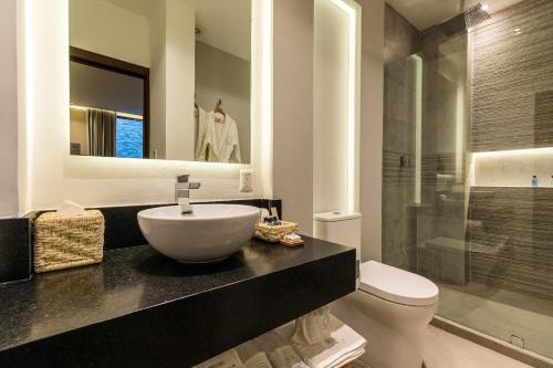 a bathroom with a sink and a toilet and a shower at Casa Naila Hotel Boutique in Oaxaca City