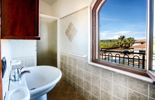 a bathroom with a sink and a window with a view at Hotel Gran Duca in Briatico