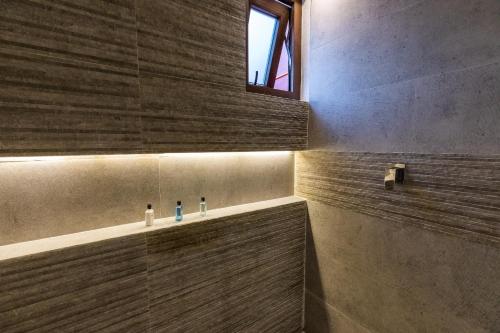 a bathroom with a sink and a window at Casa Naila Hotel Boutique in Oaxaca City