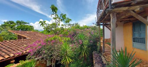 a house with purple flowers on the side of it at Hotel Spa El Cogollo By MH in Barichara