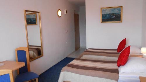 a hotel room with two beds and a mirror at Hotel As in Biała Podlaska