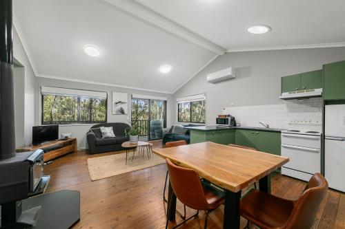 a kitchen and living room with a wooden table at Cottages On Mount View in Mount View