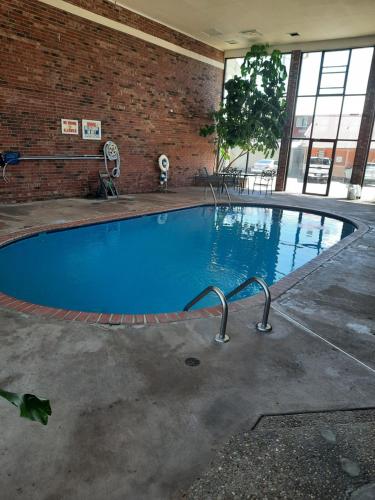 a large swimming pool in a brick building at Blue Ribbon Inn and Suites in Sallisaw