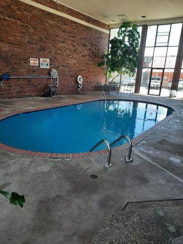 ein großer Pool in einem Backsteingebäude in der Unterkunft Blue Ribbon Inn and Suites in Sallisaw