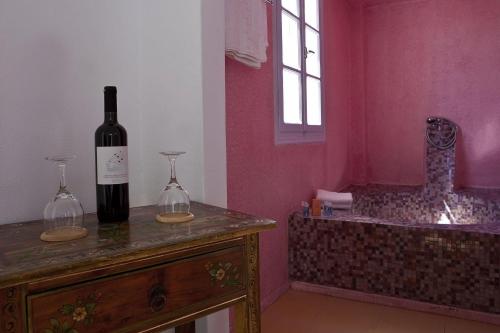 a bottle of wine sitting on top of a counter at Tzekos Villas in Fira