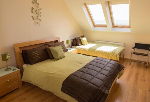 a bedroom with two beds and two windows at On the Rocks B&B in Greencastle