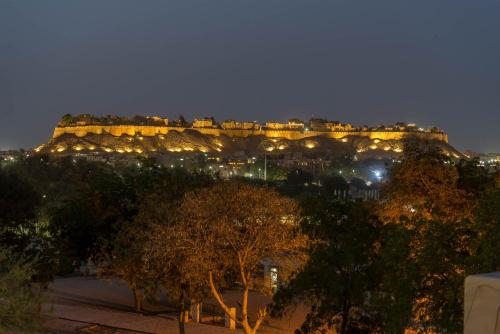 a view of the acropolis lit up at night at Hotel Helsinki House in Jaisalmer