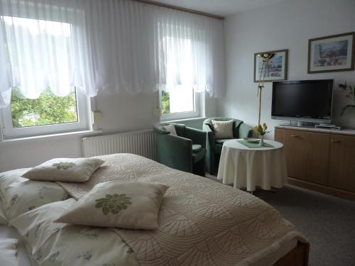 Ένα ή περισσότερα κρεβάτια σε δωμάτιο στο Pension Rheingold Garni