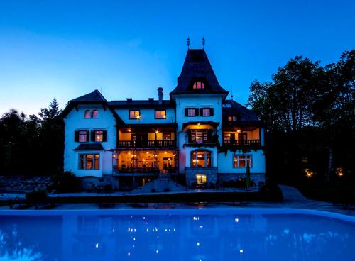 a large house with a pool in front of it at Landhaus Koller in Gosau