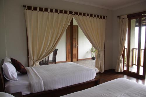Кровать или кровати в номере Munduk Sari Resort