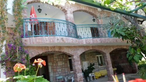 a building with a balcony on top of it at Zoro Apartments in Sveti Stefan