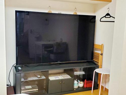 a large flat screen tv on a wall at Takaraboshi room 201 Sannomiya 10 min in Kobe