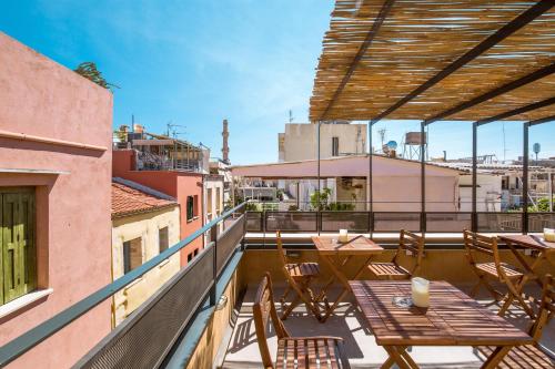 a balcony with tables and chairs on a building at Thallos The Boutique in Chania Town