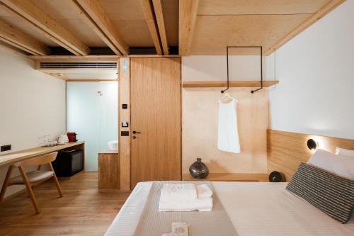 a bedroom with a bed and a desk and a table at Thallos The Boutique in Chania Town
