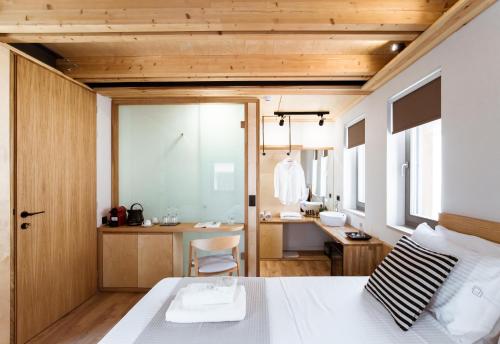 a bedroom with a bed and a bathroom at Thallos The Boutique in Chania Town