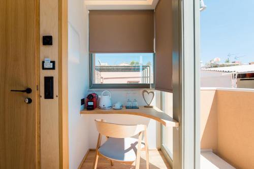 a small desk in a room with a window at Thallos The Boutique in Chania Town