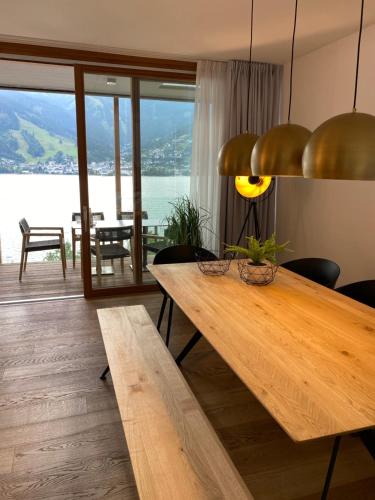 a dining room with a table and a view of the ocean at Residence Bellevue - incl Summercard in Zell am See