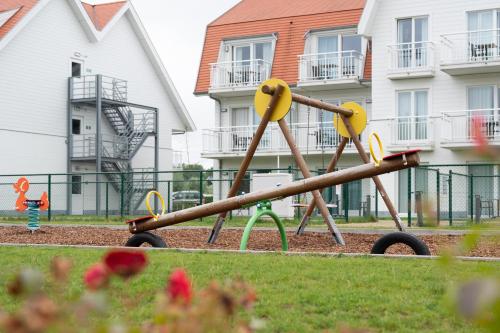 a playground in a yard next to some buildings at ibis Styles Nieuwpoort in Nieuwpoort