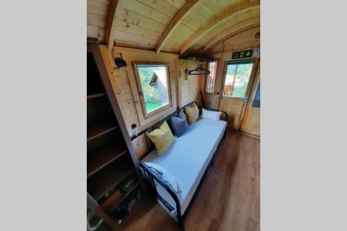 a bed in the middle of a tiny house at Autarkes Tiny House mit Rheinblick in Rümikon