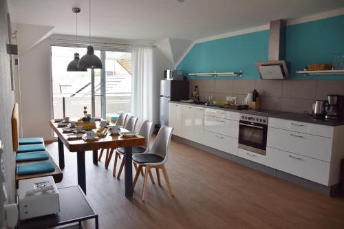 a kitchen with a table and chairs and a dining room at Ferienwohnung auf dem Dorf, Külsheim in Külsheim